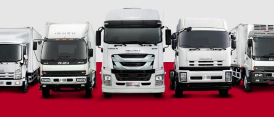 A line-up of white commercial trucks and tractor units photographed against a red backdrop.